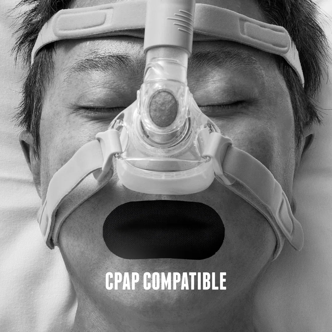 Man sleeping with CPAP mask and Hostage Tape mouth tape for better breathing and sleep