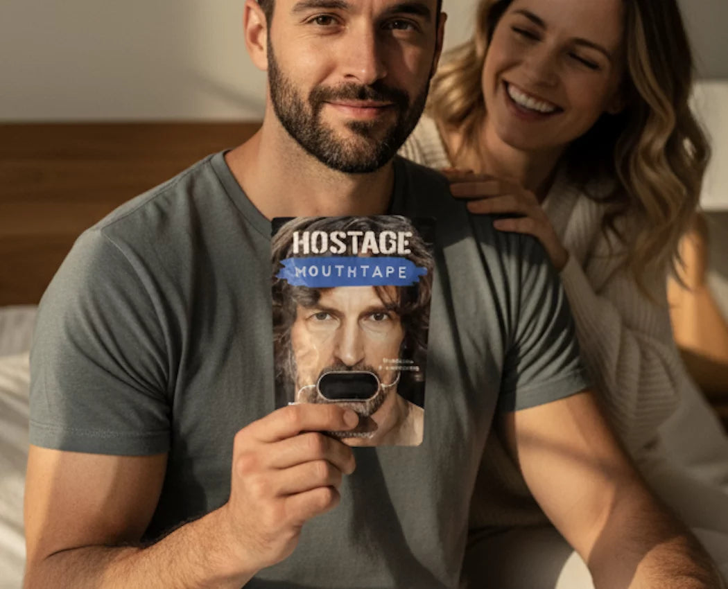 Hostage Tape mouth tape packaging held by smiling man with partner in warm morning light, promoting better sleep and snoring relief