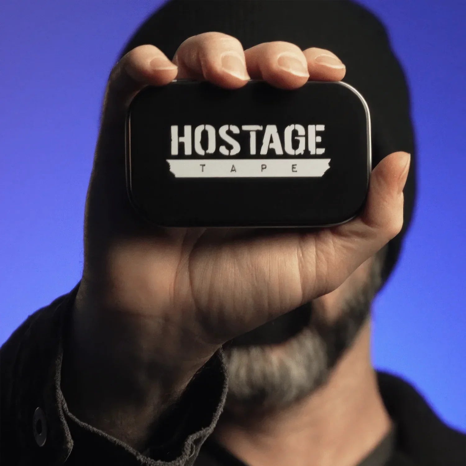 Hostage Mouth Tape metal storage tin held in hand for size reference and convenience