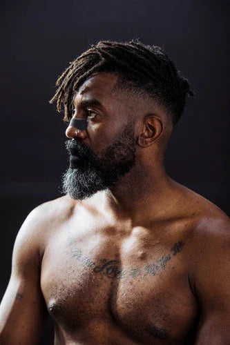 Man wearing Hostage Mouth Tape and Nose Strips for better sleep and breathing