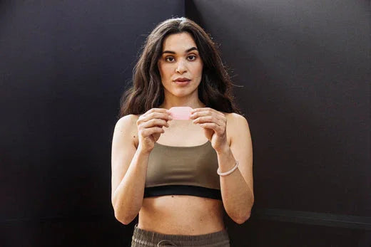 oman holding pink Hostage Tape for better sleep and snoring relief