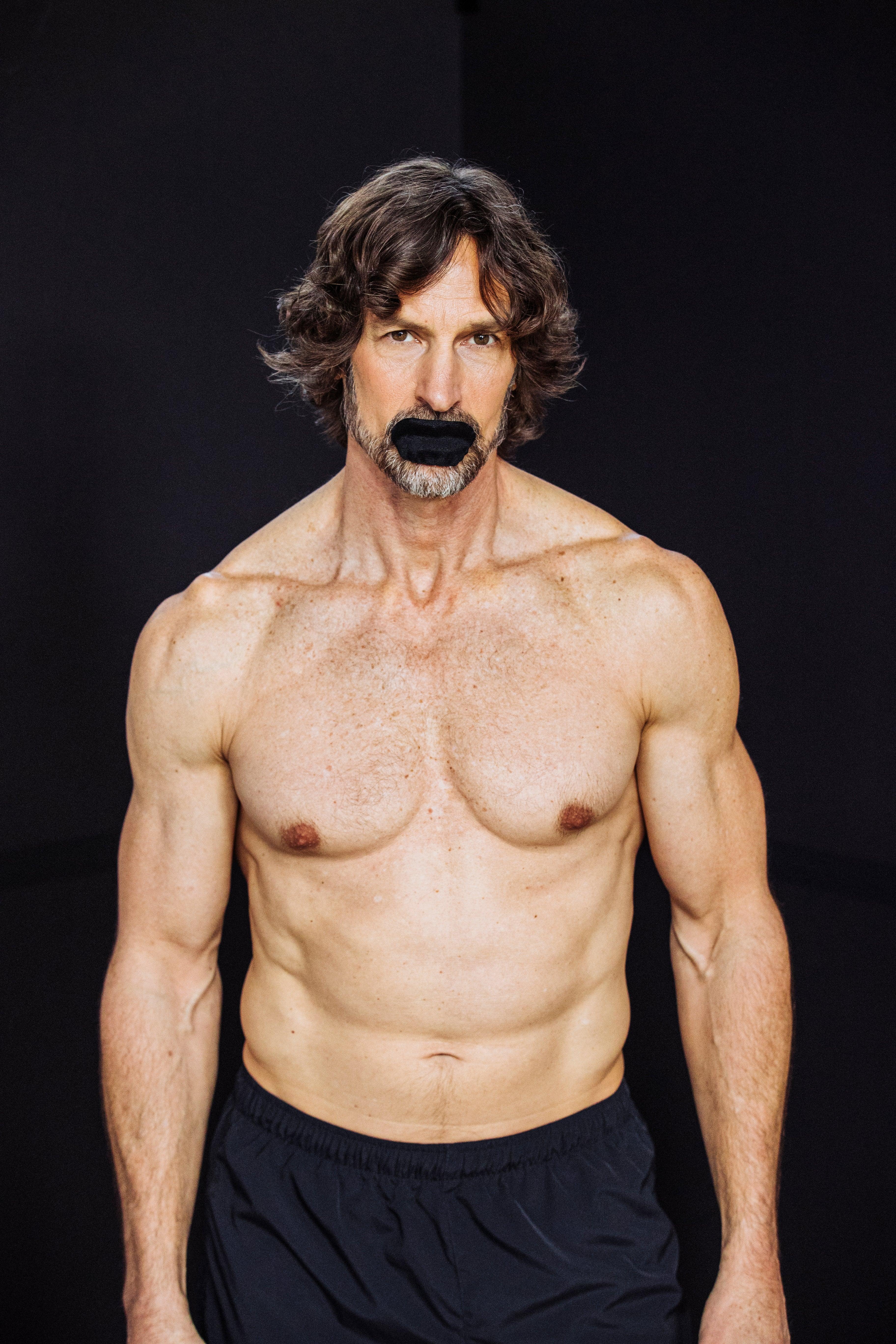 Fit middle-aged man wearing Hostage Mouth Tape for better sleep and improved breathing