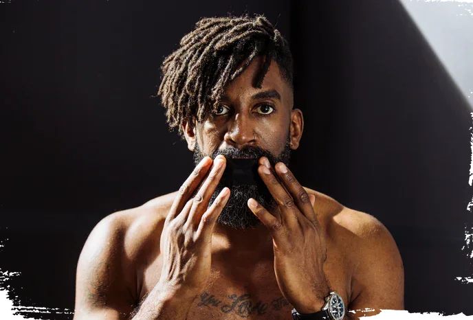 Bearded man applying Hostage Mouth Tape for better sleep and nasal breathing