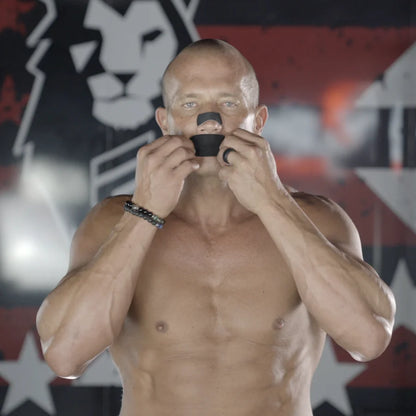 Andy Elliott applying black Hostage Mouth Tape and Nose Strips for better sleep