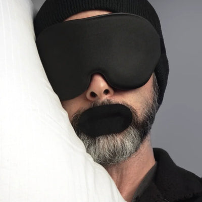 Man sleeping with black Hostage Tape mouth tape and blindfold 