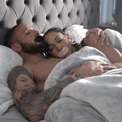 Man and woman sleeping with Hostage Mouth Tape