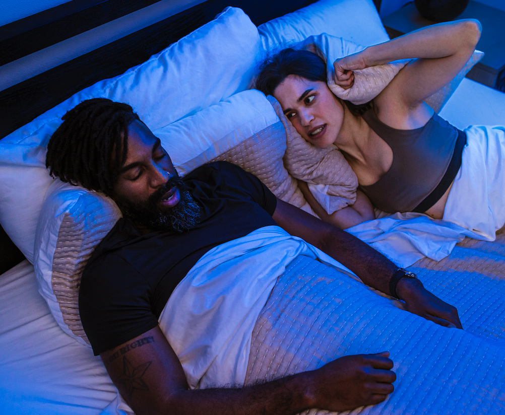 Couple sleeping peacefully with Hostage Nose Strips