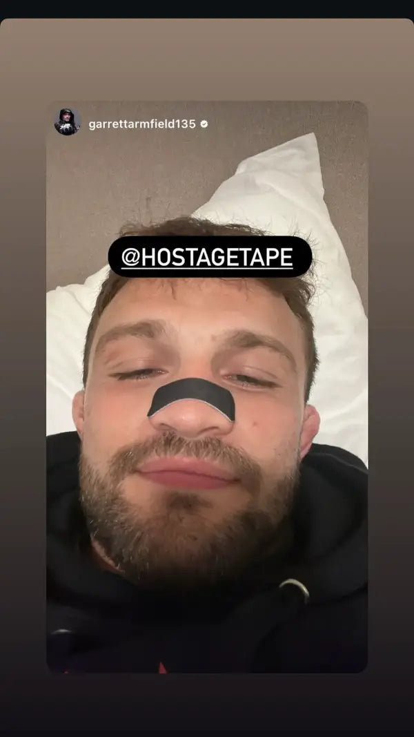 Man wearing a Hostage Nose Strip in bed