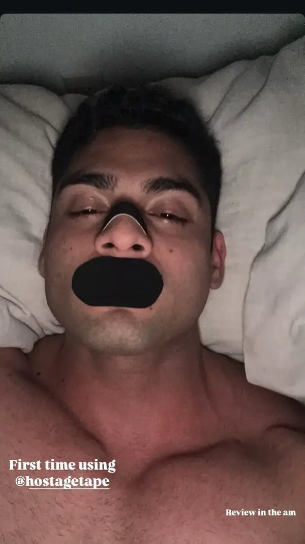 Hostage Tape customer using the product in bed